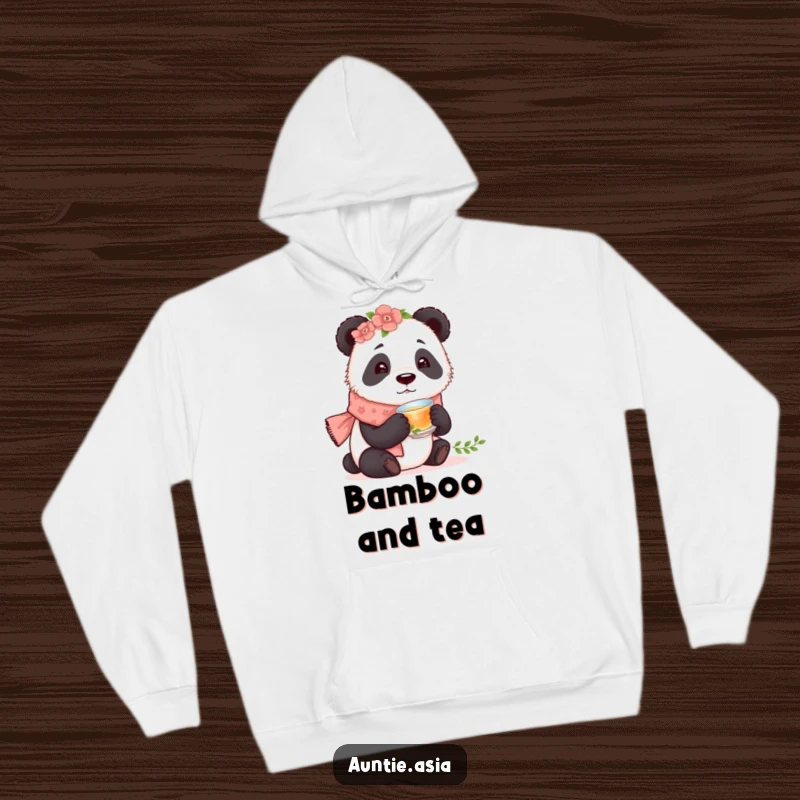Funny curious panda wearing a floral scarf, holding a tiny teacup, a cozy and humorous hoodie.